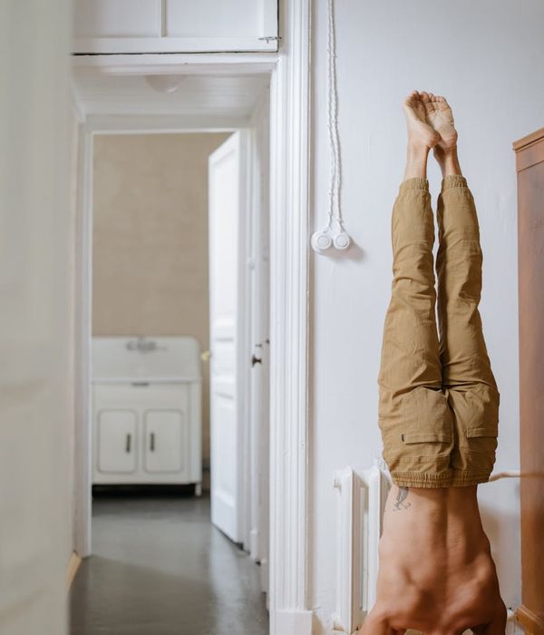 Man performing a controlled strength exercise in a minimalist environment.